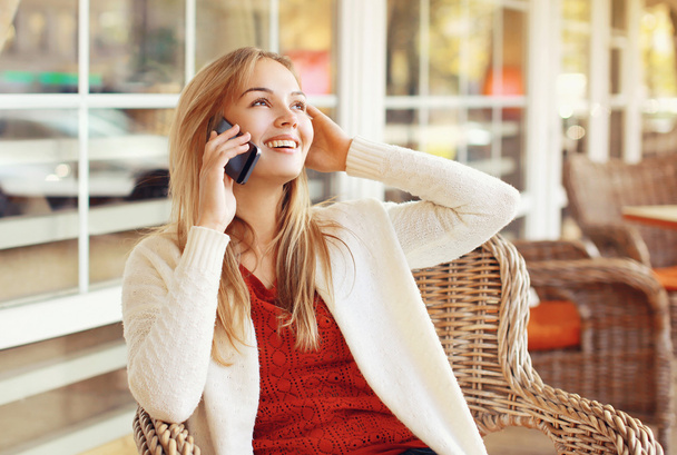Happy woman talking on the smartphone outdoors - Foto, Bild