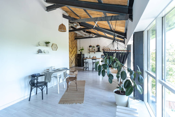 stylish kitchen interior design. white walls and wooden decoration. beautiful hammock and high windows. - Foto, Bild