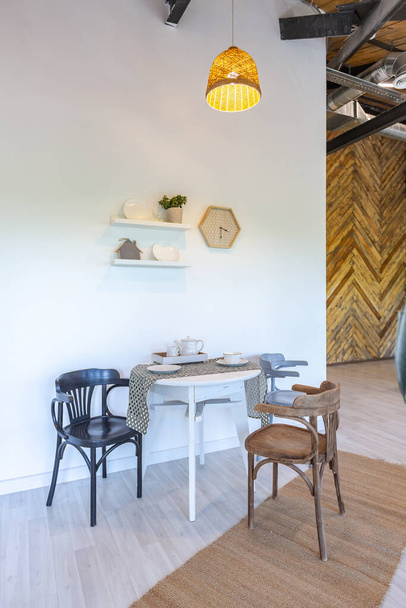 stylish kitchen interior design. white walls and wooden decoration. beautiful hammock and high windows. - Фото, изображение