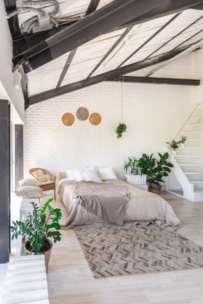 Luxury bedroom design in a rustic cottage in a minimalist style. white walls, panoramic windows, wooden elements of decoration on the ceiling, rope swings in the middle of a spacious room. - Fotoğraf, Görsel