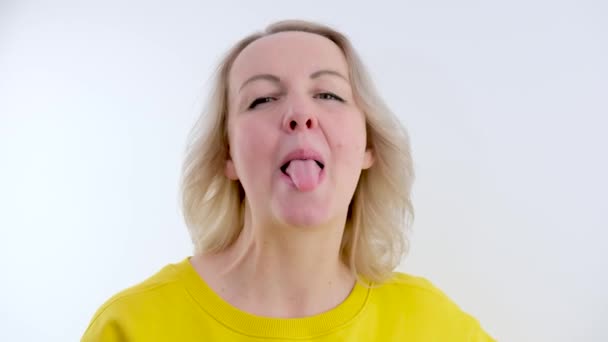 Fooling around outside, sticks out tongue as sign of disobedience, protest, disrespect. Human emotions, reactions, feelings, attitude, having fun, grimacing healthy oral cavity. Attractive woman - Footage, Video