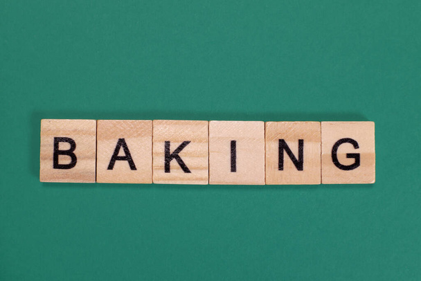 Baking word from wooden letters on green background - Photo, image