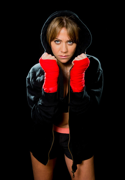 young sexy boxing girl with wrapped hands and wrists in hoodie jumper ready for fight - Photo, Image
