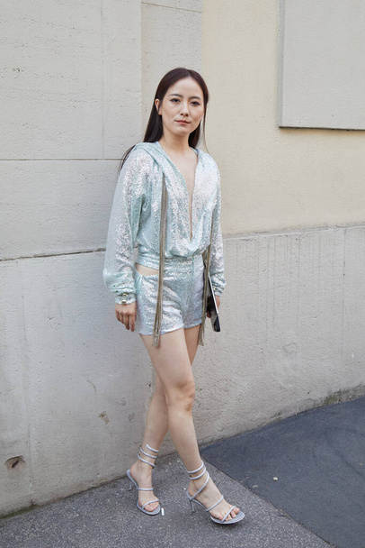 MILAN, ITALY - FEBRUARY 23, 2023: Woman with sequin turquoise and silver jacket and shorts before Genny fashion show, Milan Fashion Week street style - Zdjęcie, obraz
