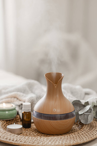 Cozy spa composition with aroma oil diffuser lamp on a blurred background. - Photo, Image