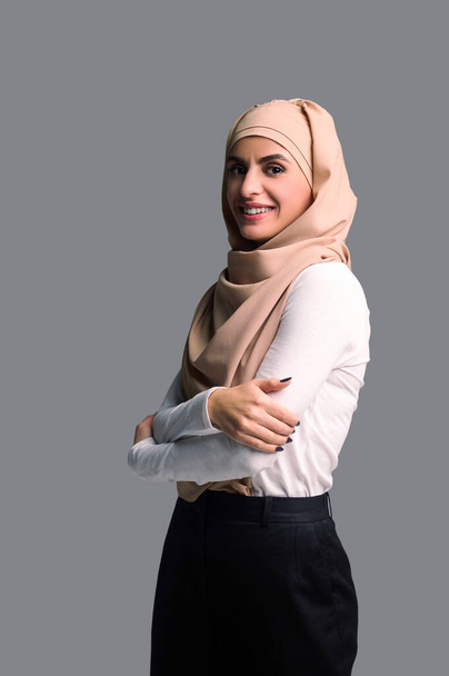 Mujer en hiyab. Mujer bonita sonriente en hijab beige - Foto, imagen
