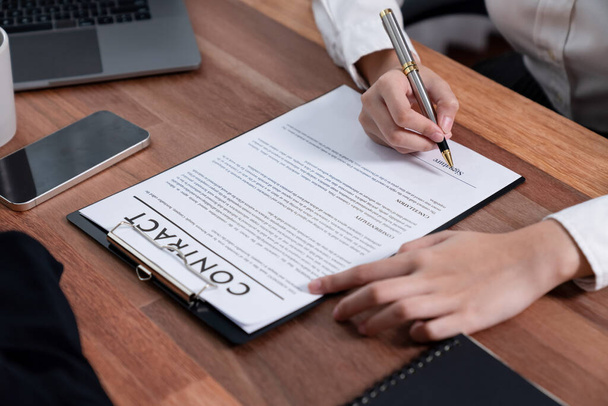 Closeup hand signing contract document with pen, sealing business deal with signature. Businesspeople finalizing business agreement by writing down signature on contract paper. Enthusiastic - Фото, зображення