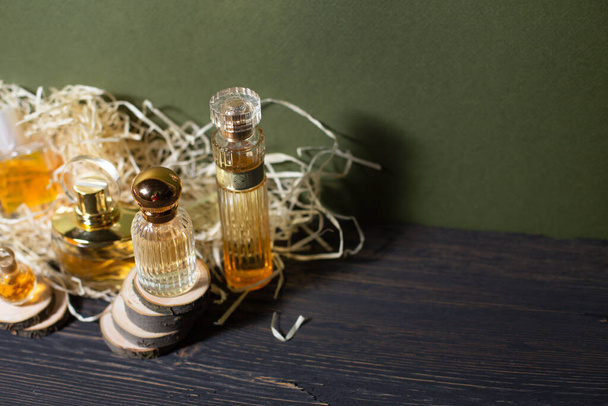 perfume with wood shavings on a black background - Photo, Image