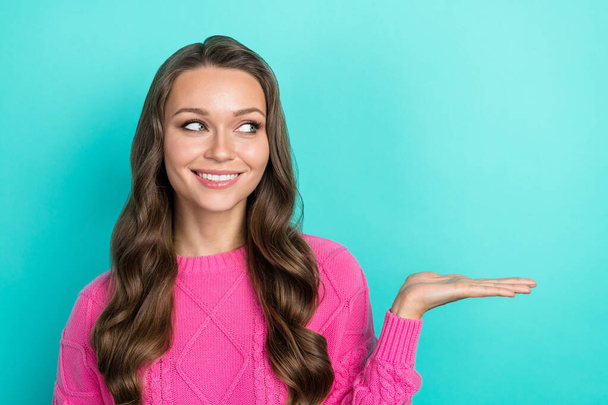Portrait of cheerful stunning lovely girl wear trendy pink clothes arm demonstrate empty space ad promo isolated on cyan color background. - Photo, Image