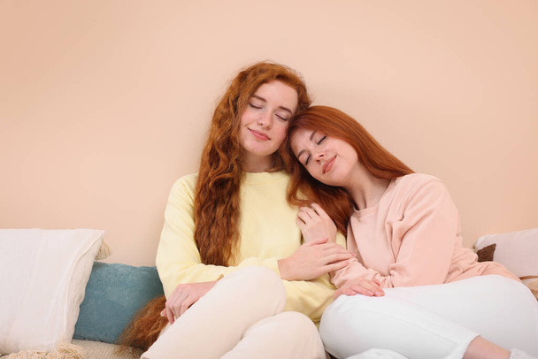 Portrait of beautiful young redhead sisters in bedroom. Space for text - Foto, Imagem