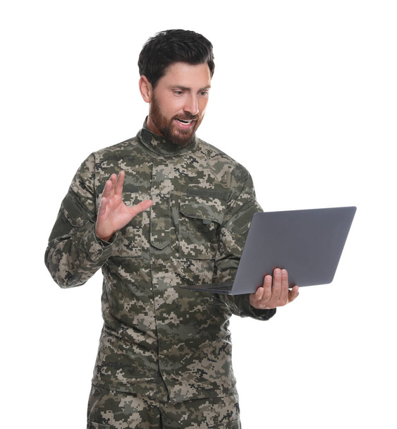 Soldier using video chat on laptop against white background. Military service - Photo, Image