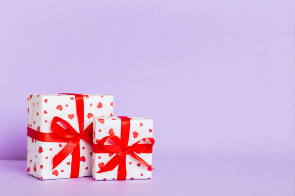 gift box with red bow and red heart on colored background. Perspective view. Flat lay. - Photo, Image