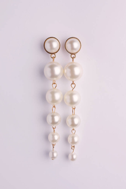 Elegant pearl earrings isolated on white, top view - Photo, image