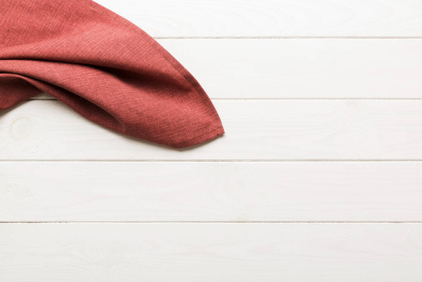 top view with red empty kitchen napkin isolated on table background. Folded cloth for mockup with copy space, Flat lay. Minimal style. - Zdjęcie, obraz