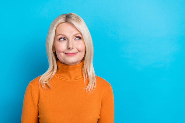 Portrait of cheerful positive senior lady wear trendy orange clothes special deal empty space isolated on blue color background. - Valokuva, kuva