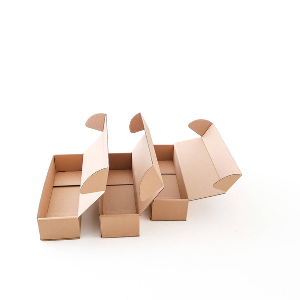 Craft empty boxes are open on a white background. Place for text and logo. The concept of packaging, delivery, food. High quality photo - Foto, Imagem