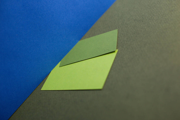 copies of design paper of different shades on a blue background - Photo, Image