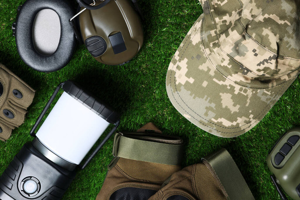 Different military training equipment on green grass, flat lay - Photo, image