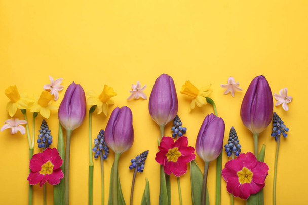 Beautiful different flowers on yellow background, flat lay. Space for text - Fotoğraf, Görsel