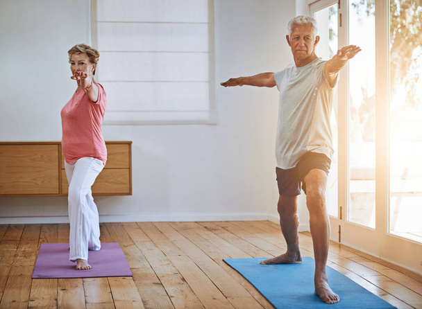 Staying active in their old age. a senior couple doing yoga together - Foto, Imagem