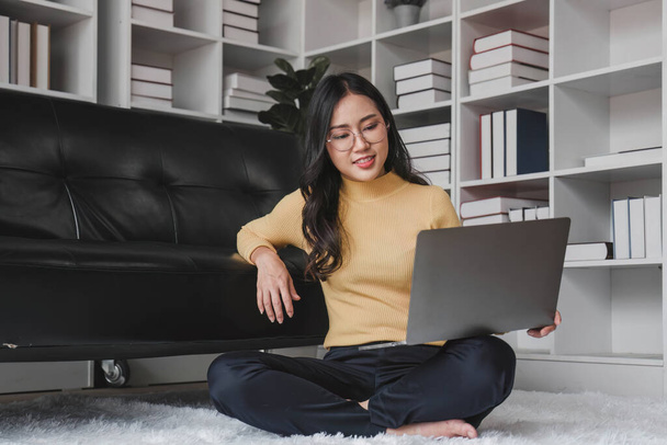 Happy young Asian business woman successful excited raised hand rejoicing with laptop at home... - Photo, Image