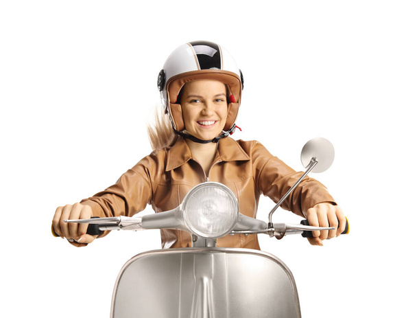 Young female with a helmet riding a scooter and smiling isolated on white background - Foto, afbeelding