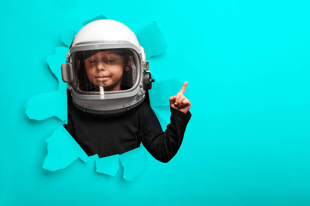 small child imagines himself to be an astronaut in an astronaut's helmet.  - Foto, afbeelding