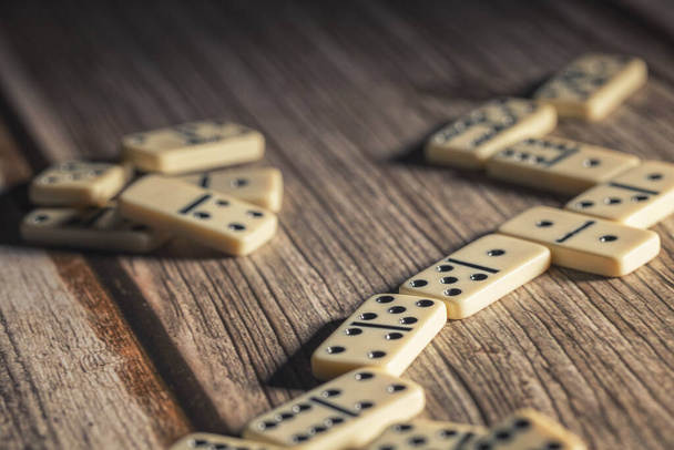 a group of beige domino blocks are laid out on the table for the game - Photo, Image
