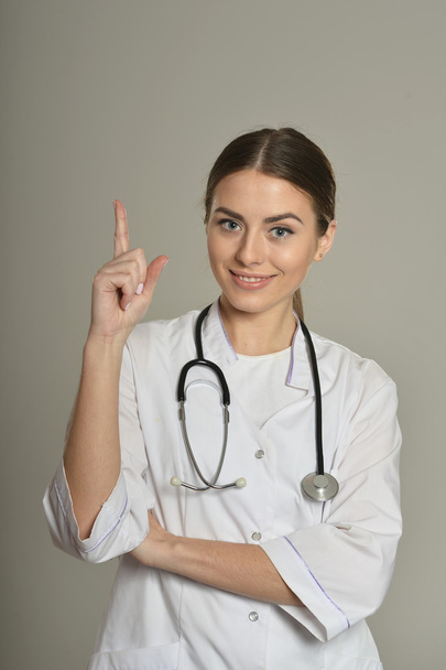 Female doctor pointing up - Photo, Image