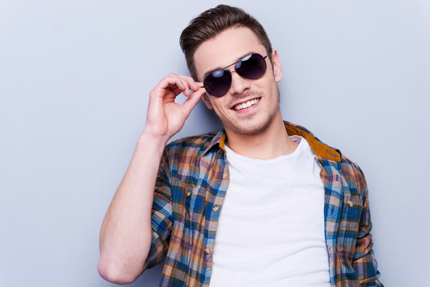 Man in shirt adjusting sunglasses - Foto, immagini