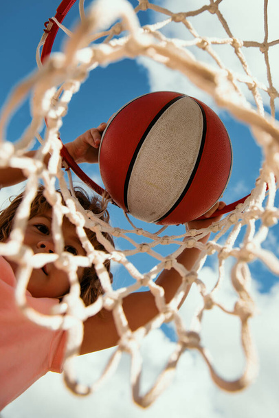 Kid playing basketball. View of flying ball to basket from top, kid play basketball - Foto, Imagem
