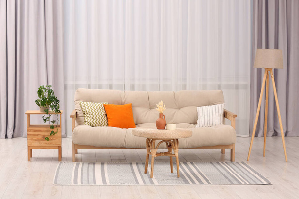 Comfortable sofa, coffee table and houseplant in stylish living room. Interior design - Valokuva, kuva