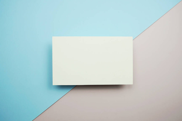 Empty greeting card mockup, horizontal invitation template on blue and pink background - Photo, image