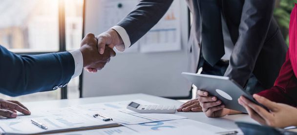 Business handshake for teamwork of business merger and acquisition,successful negotiate,hand shake,two businessman shake hand with partner to celebration partnership and business deal concept - 写真・画像