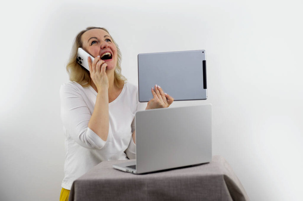 Woman sit on sofa put pc on lap clenched fists scream with joy while read great news on laptop. Gambler celebrate online auction bet victory. Got incredible offer sincere emotions of happiness - Photo, Image