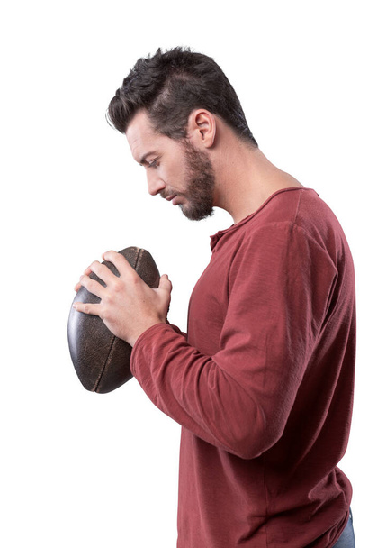 Young attractive football player playing with ball on gray background - Fotó, kép