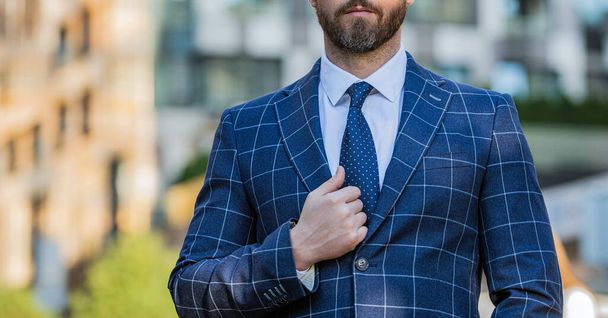 cropped view of business employee wearing jacket in the street. photo of business employee with tie. business employee outdoor. business employee on urban background. - 写真・画像
