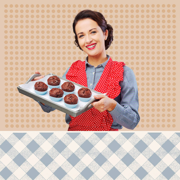 Smiling vintage woman in apron serving homemade chocolate muffins on a tray - Fotografie, Obrázek