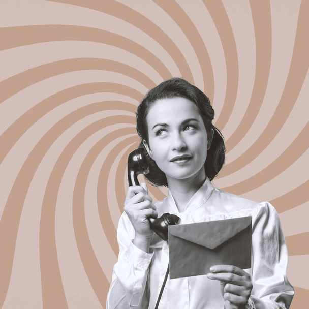 Vintage secretary on the phone holding a closed envelope - Фото, зображення