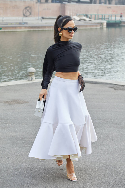 MILAN, ITALY - FEBRUARY 24, 2023: Anna Rosa Vitiello with white skirt and black top before Sportmax fashion show, Milan Fashion Week street style - Φωτογραφία, εικόνα