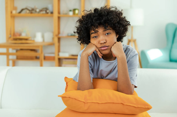 African american sad thoughtful girl at home. Young african woman feels depressed offended lonely upset suffers from abuse harassment heartbreak. Grieving violence victim has psychological problem - Foto, imagen