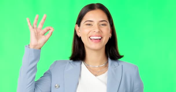 Ok hands, face and happy woman on green screen, background and review of business support. Portrait of female employee, smile and okay for success, yes and bonus for perfect emoji, thank you and sign. - Footage, Video