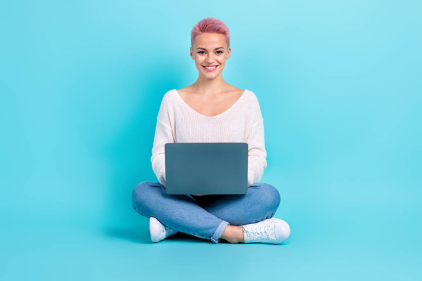 Full length photo of positive project manager pretty young lady sitting crossed legs writing netbook tasks isolated on aquamarine color background. - Foto, Bild