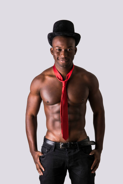 Attractive black young muscle man naked, wearing only pants and red necktie, isolated on white - Foto, Imagem