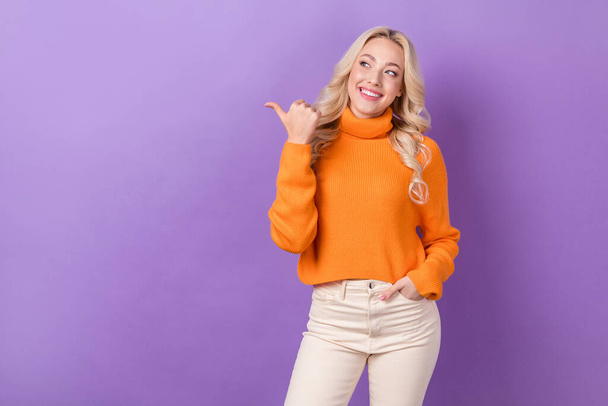 Portrait of positive nice person toothy smile look direct finger empty space isolated on purple color background. - Foto, imagen