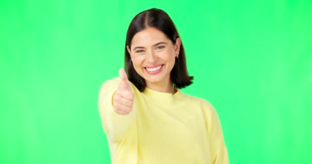 Happy woman, thumbs up and green screen for winning, success or agreement against a studio background. Portrait of female face with smile showing thumb emoji, yes sign or like on chromakey mockup. - Footage, Video