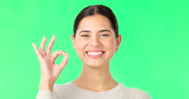 Face, green screen and woman with ok sign, smile and approval against a studio background. Portrait, female and person with symbol for perfect, hand gesture for support and motivation with happiness. - Footage, Video