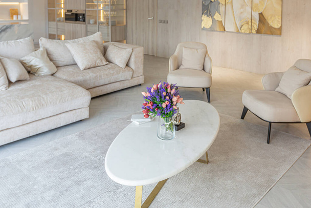 modern interior design of the living area in the studio apartment in warm soft colors. decorative built-in lighting and soft beige furniture - Foto, immagini