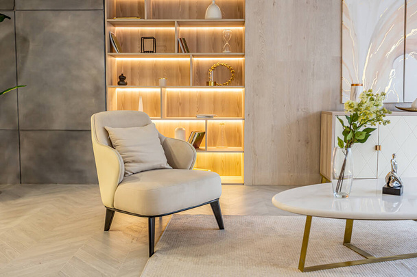 diseño interior moderno de la sala de estar en el apartamento estudio en colores cálidos y suaves. iluminación incorporada decorativa y muebles de color beige suave - Foto, imagen