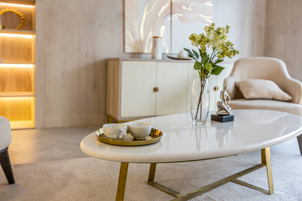 modern interior design of the living area in the studio apartment in warm soft colors. decorative built-in lighting and soft beige furniture - 写真・画像